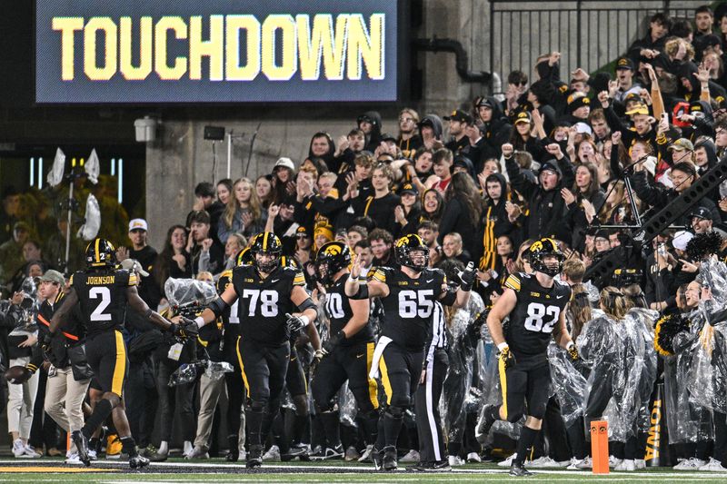 Nov 2, 2024; Iowa City, Iowa, USA; Iowa Hawkeyes running back Kaleb Johnson (2) and offensive lineman Mason Richman (78) and offensive lineman Logan Jones (65) and tight end Johnny Pascuzzi (82) react after a touchdown during the third quarter against the Wisconsin Badgers at Kinnick Stadium. Mandatory Credit: Jeffrey Becker-Imagn Images