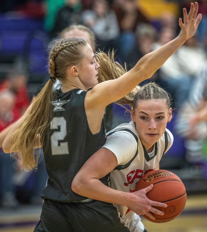 Stevens Point Area Senior High Jada Seubert (5) pushes past Lakeland Bobbi Lee (2) during a Girls National division basketball game on the second day of the Sentry Classic at University of Wisconsin Stevens Point Quandt Fieldhouse on Friday, Dec 27, 2024. Lakeland won 62-55.
