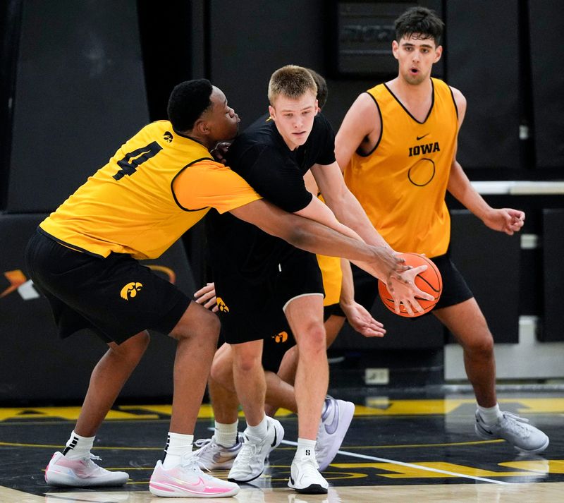 Iowaâ€™s Cam Manyawu (4) tries to knock the ball away from Bennett Stirtz (14) during practice June 19, 2025 at Carver-Hawkeye Arena in Iowa City, Iowa.