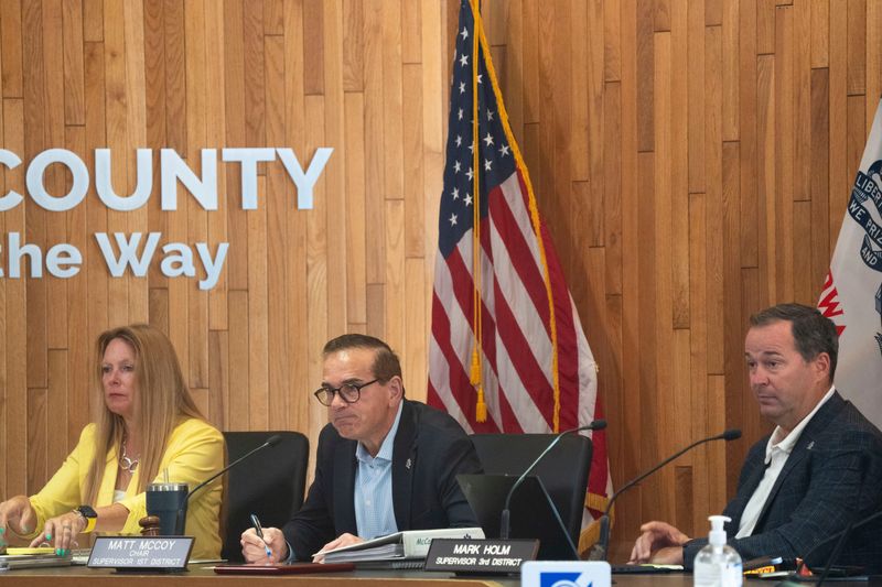 From left: Polk County Supervisors Jill Altringer, Matt McCoy and Mark Holm listen to a speaker during a Polk County Board of Supervisors meeting at the Polk County Administration Building on July 29, 2025, in Des Moines. Supervisors Tom Hockensmith and Angela Connolly were present remotely.