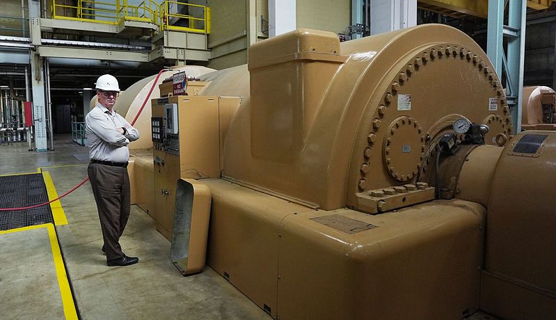City of Ames Electric Services Director Don Kim shows off a generator while giving a tour of the Ames power plant on Aug. 5, 2025, in Ames, Iowa