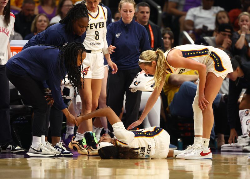 Aug 7, 2025; Phoenix, Arizona, USA; Indiana Fever guard Sydney Colson (51) reacts alongside teammate Lexie Hull after suffering an injury against the Phoenix Mercury in the first half of a WNBA game at PHX Arena. Mandatory Credit: Mark J. Rebilas-Imagn Images