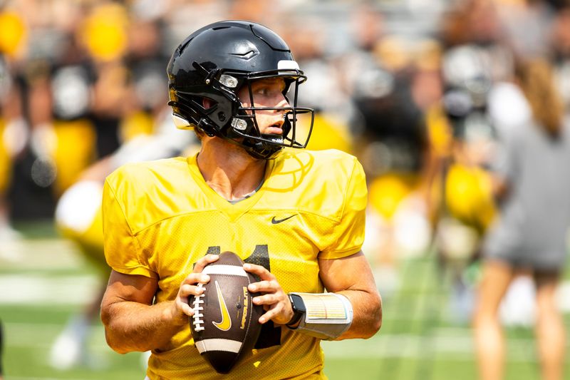 Aug 9, 2025; Iowa quarterback Mark Gronowski (11) runs a drill during the Hawkeyes Kids Day NCAA football open practice at Kinnick Stadium in Iowa City, Iowa. Mandatory Credit: Joseph Cress for the Des Moines Register
