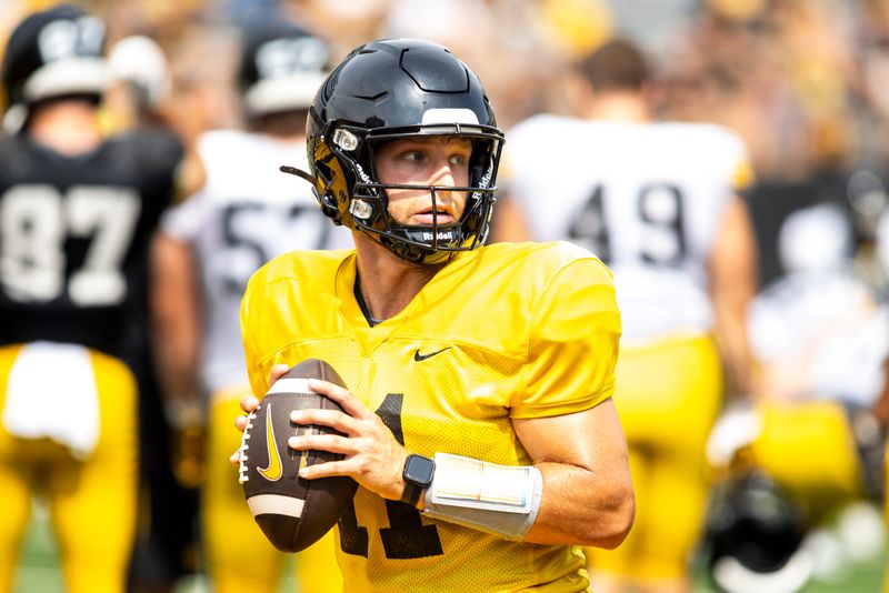 Aug 9, 2025; Iowa quarterback Mark Gronowski (11) runs a drill during the Hawkeyes Kids Day NCAA football open practice at Kinnick Stadium in Iowa City, Iowa. Mandatory Credit: Joseph Cress for the Des Moines Register