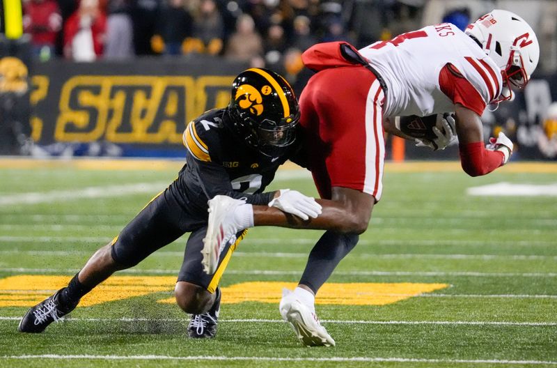 Iowa Hawkeyes defensive back TJ Hall (2) tackles Nebraska Cornhuskers wide receiver Jahmal Banks (4) Friday, Nov. 29, 2024 at Kinnick Stadium in Iowa City, Iowa.