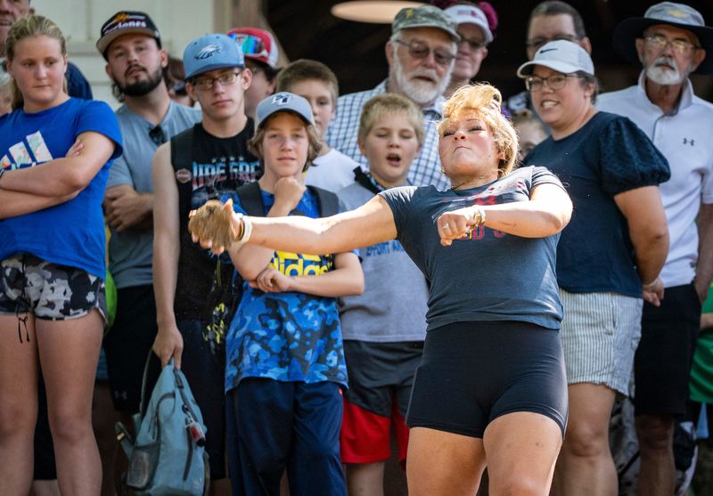 Sophie Davis of Norwalk tosses cow poop for distance during the Cow Chip Throwing contest at the Iowa State Fair, Aug. 13, 2025.