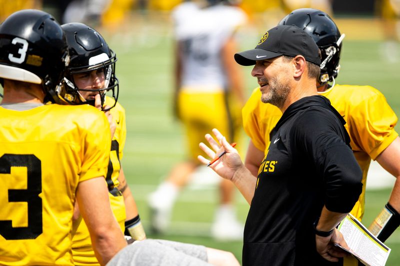 Aug 9, 2025; Iowa offensive coordinator and quarterbacks coach Tim Lester talks with players during the Hawkeyes Kids Day NCAA football open practice at Kinnick Stadium in Iowa City, Iowa. Mandatory Credit: Joseph Cress for the Des Moines Register