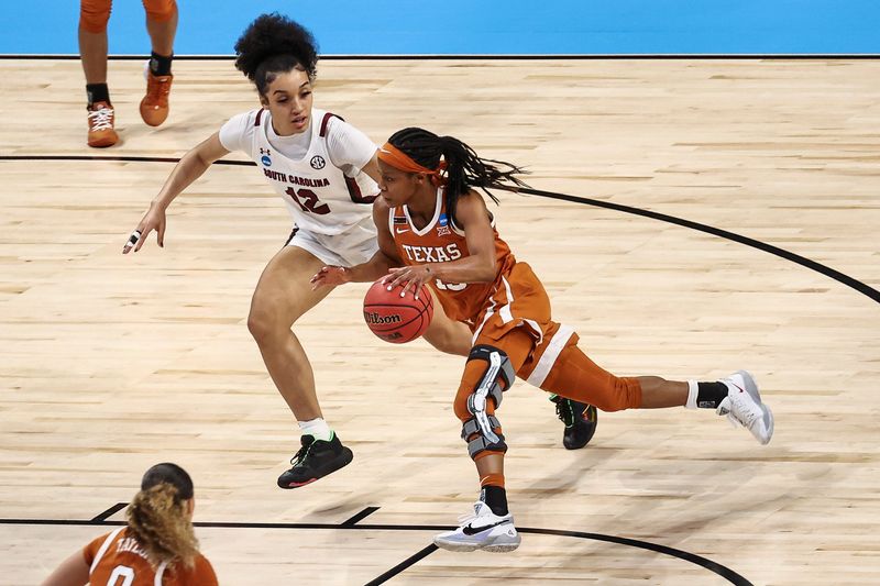 Mar 30, 2021; San Antonio, Texas, USA; Texas Longhorns guard Kyra Lambert (15) drives with the ball while defended by South Carolina Gamecocks guard Brea Beal (12) during the first quarter at Alamodome. Mandatory Credit: Troy Taormina-USA TODAY Sports