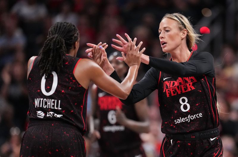 Indiana Fever guard Sophie Cunningham (8) high-fives Indiana Fever guard Kelsey Mitchell (0) on Tuesday, Aug. 12, 2025, during the game at Gainbridge Fieldhouse in Indianapolis.