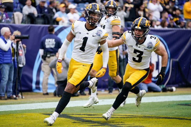 Iowa defensive back Xavier Nwankpa (1) celebrates his touchdown with Cooper DeJean (3) against Kentucky during the Music City Bowl on Dec. 31, 2022, in Nashville, Tenn.