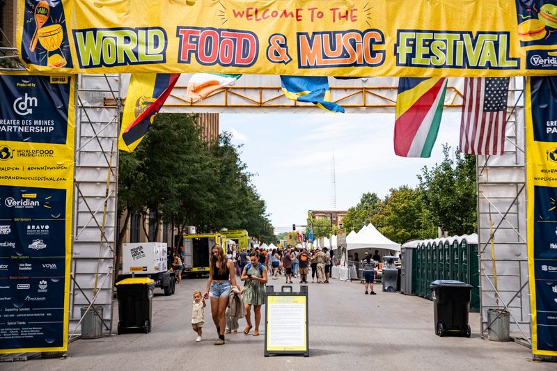 People walk down Locust Street during the World Food and Music Festival on Aug. 22, 2025, at Western Gateway Park in Des Moines, Iowa.