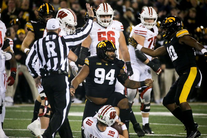 Iowa defensive lineman Yahya Black (94) tackled Wisconsin quarterback Braedyn Locke (18) in the Saturday, Nov. 2, 2024 at Kinnick Stadium in Iowa City, Iowa.