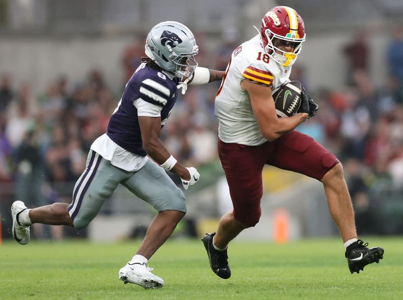 Aug 23, 2025; Dublin, IRELAND; Iowa State player Benjamin Brahmer runs with the ball against Qua Moss of Kansas State during the Aer Lingus Classic between Iowa State and Kansas State at Aviva Stadium. Mandatory Credit: Laszlo Geczo/INPHO via Imagn Images
