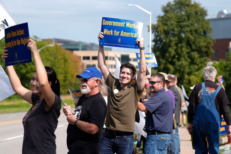 People gather outside the Iowa City VA Hospital in solidarity with American Federation of Government Employees during a protest Aug. 27, 2025 in Iowa City, Iowa.