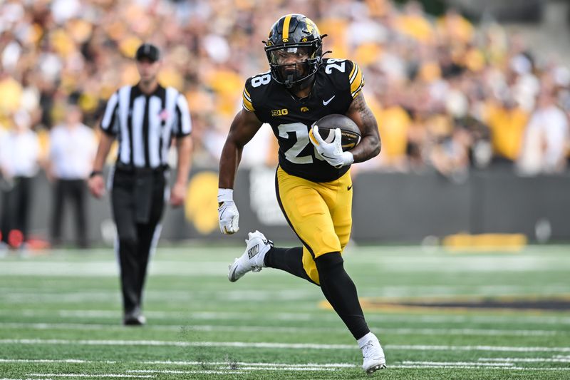 Aug 30, 2025; Iowa City, Iowa, USA; Iowa Hawkeyes running back Kamari Moulton (28) runs the ball against the Albany Great Danes during the first quarter at Kinnick Stadium. Mandatory Credit: Jeffrey Becker-Imagn Images