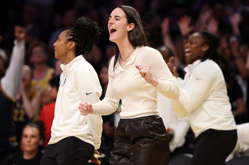 Aug 29, 2025; Los Angeles, California, USA; Indiana Fever guard Caitlin Clark (22) reacts after a teammate makes a basket during the second half against the Los Angeles Sparks at Crypto.com Arena. Mandatory Credit: Kiyoshi Mio-Imagn Images