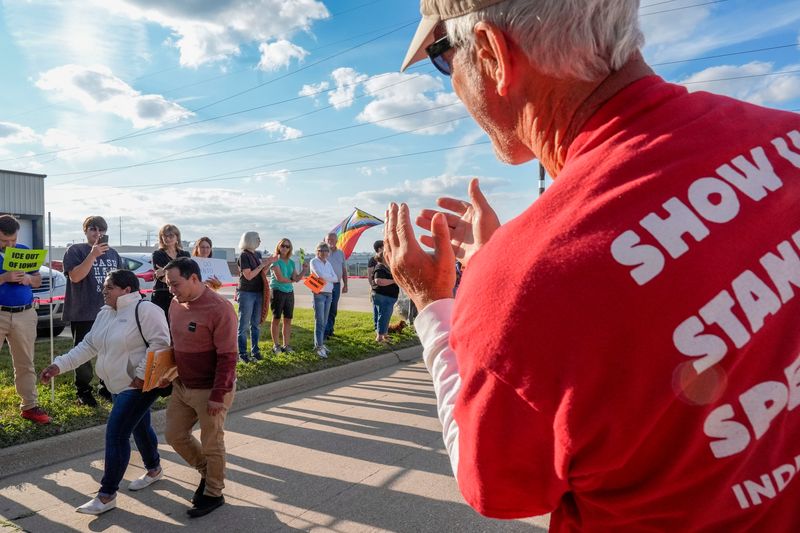 Protesters applaud immigrants as they leave their routine check-ins with ICE Sept. 2, 2025 at the Homeland Security Investigations building in Cedar Rapids, Iowa.