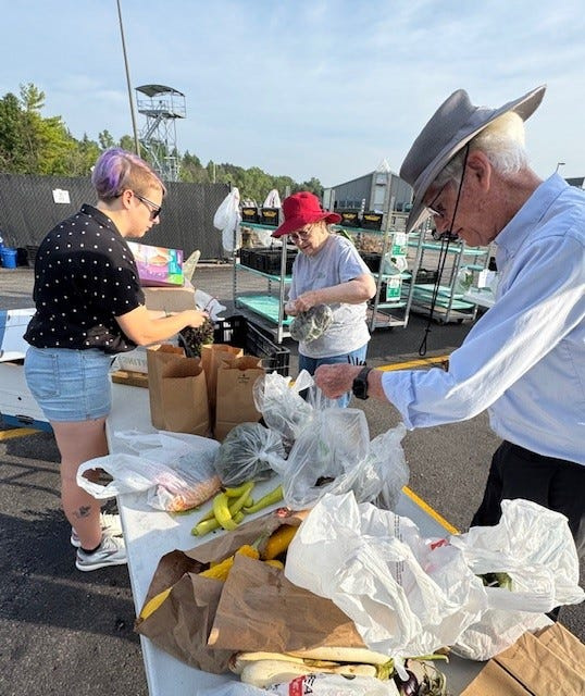 Intern Cara Olsen and volunteers Dorothy Lewis and Donald Lewis are an example of volunteers and staff working together every Monday morning to collect donations from community members. They weigh, sort and deliver produce to food pantries.