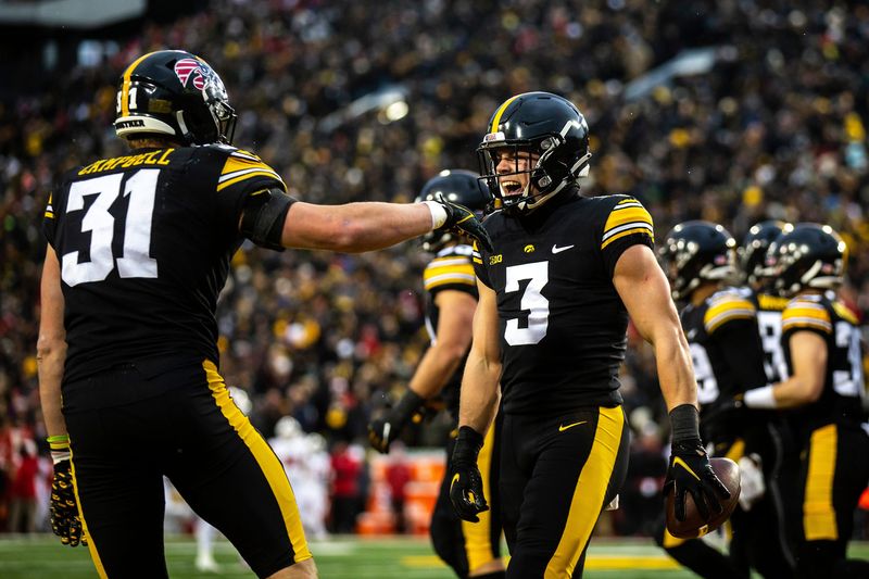 Iowa defensive back Cooper DeJean (3) celebrates with linebacker Jack Campbell after returning an intercepted pass for a touchdown during a NCAA Big Ten Conference football game against Wisconsin, Saturday, Nov. 12, 2022, at Kinnick Stadium in Iowa City, Iowa.