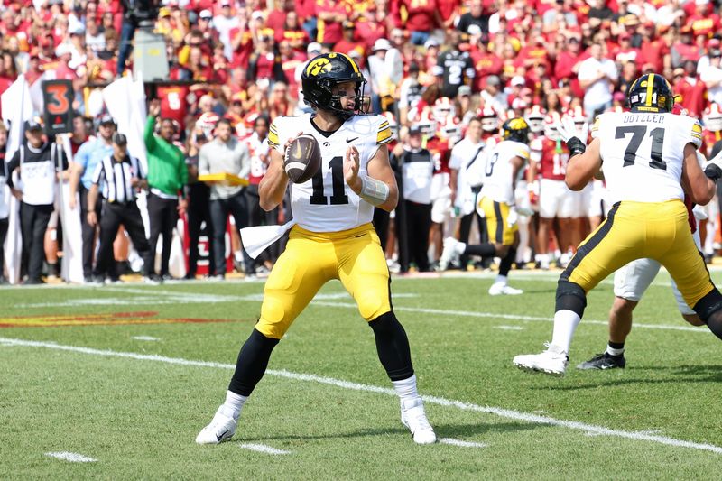 Sep 6, 2025; Ames, Iowa, USA; Iowa Hawkeyes quarterback Mark Gronowski (11) looks to pass the ball against the Iowa State Cyclones during the first quarter at Jack Trice Stadium. Mandatory Credit: Reese Strickland-Imagn Images