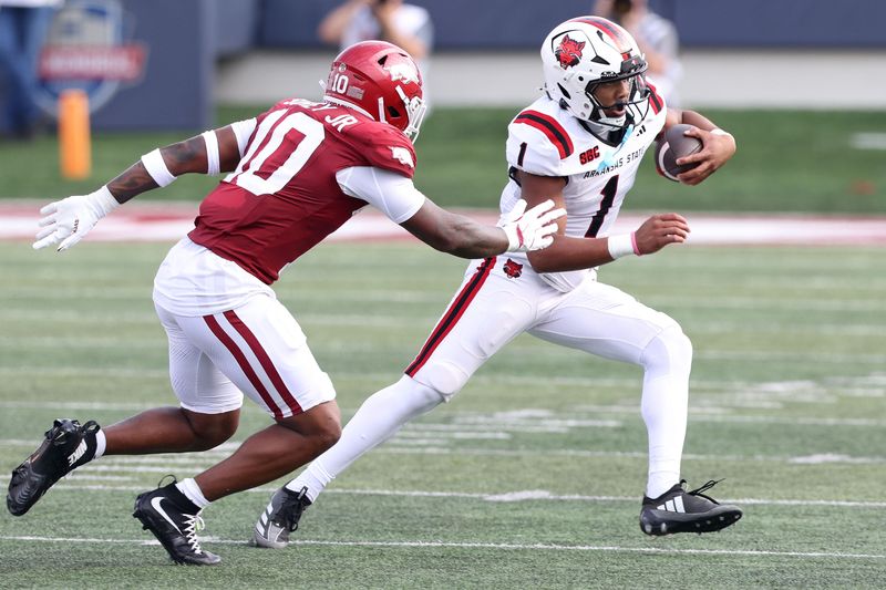 Sep 6, 2025; Little Rock, Arkansas, USA; Arkansas State Red Wolves quarterback Jaylen Raynor (1) rushes during the first quarter against the Arkansas Razorbacks at War Memorial Stadium.