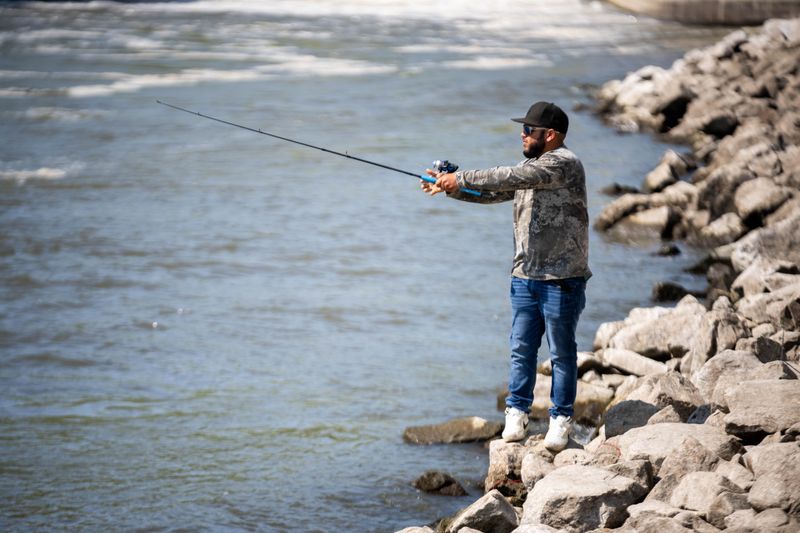 Cesar Acosta casts his line into the Des Moines River on Monday, Sept. 8, 2025, at the Saylorville Dam in Johnston.