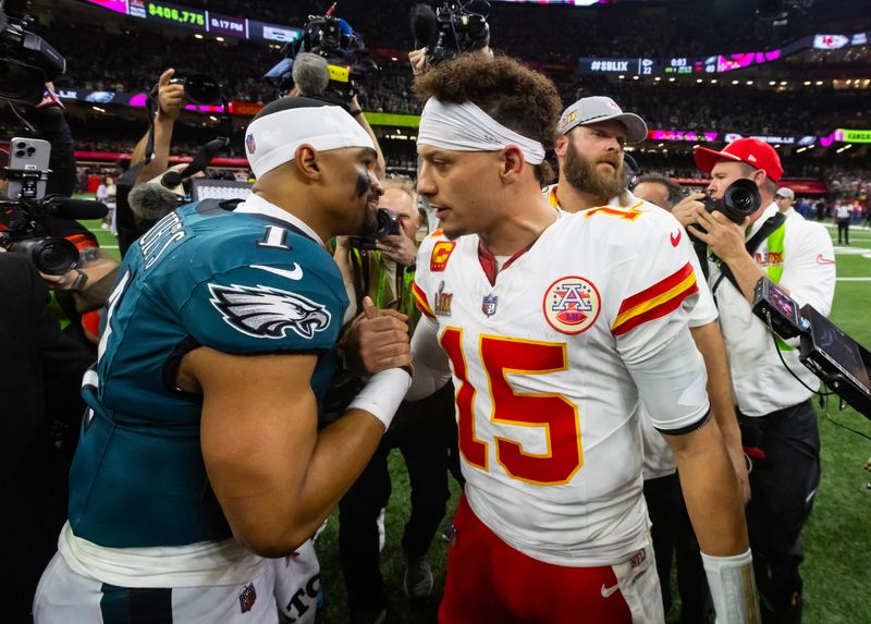 Feb 9, 2025; New Orleans, LA, USA; Philadelphia Eagles quarterback Jalen Hurts (1) greets Kansas City Chiefs quarterback Patrick Mahomes (15) following Super Bowl LIX at Ceasars Superdome. Mandatory Credit: Mark J. Rebilas-Imagn Images