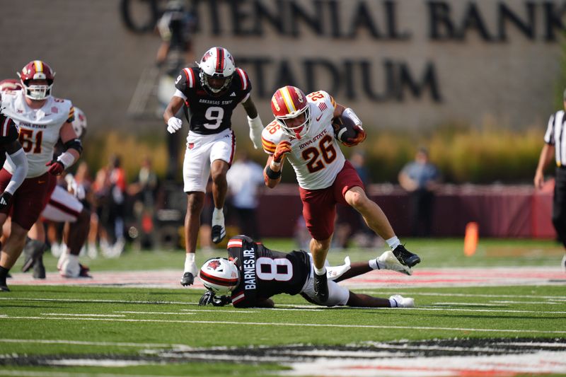 Iowa State football running back Carson Hansen hurdles a defender in the team's game at Arkansas State on Saturday, Sept. 13, 2025.