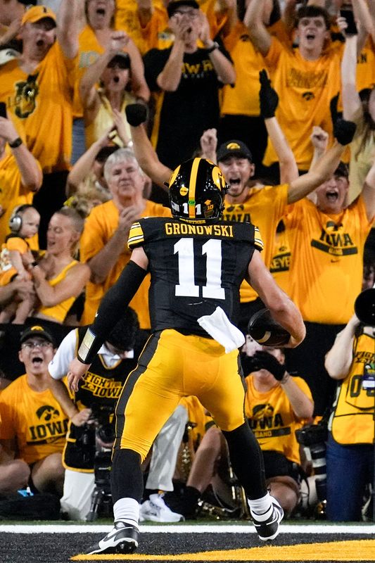 Iowa Hawkeyes quarterback Mark Gronowski (11) scores a rushing touchdown against the Massachusetts Minutemen in the second quarter Sept. 13, 2025 at Kinnick Stadium in Iowa City, Iowa.