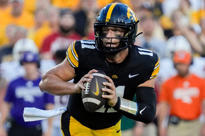 Iowa Hawkeyes quarterback Mark Gronowski (11) looks to pass the ball during a football game against the Massachusetts Minutemen Sept. 13, 2025 at Kinnick Stadium in Iowa City, Iowa.