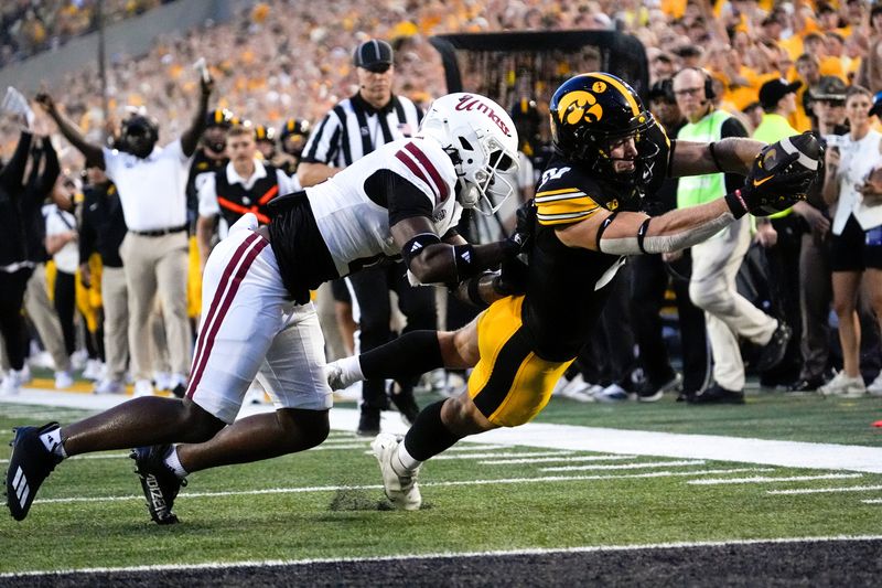 DUPLICATE***Iowa Hawkeyes wide receiver Kaden Wetjen (21) dives into the endzone to score as Massachusetts Minutemen safety DD Snyder (4) defends Sept. 13, 2025 at Kinnick Stadium in Iowa City, Iowa.