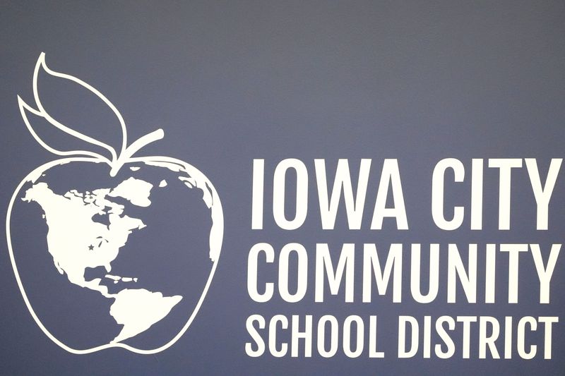 An Iowa City Community School District logo is pictured on the wall of the school board meeting room Sept. 9, 2025 in Iowa City, Iowa.