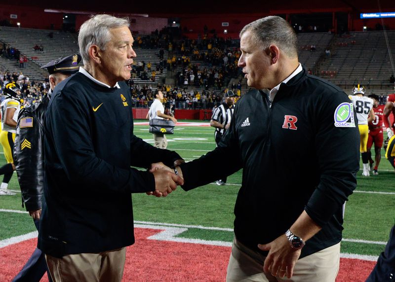 Sep 24, 2022; Piscataway, New Jersey, USA; Iowa Hawkeyes head coach Kirk Ferentz (left) shakes hands with Rutgers Scarlet Knights head coach Greg Schiano after a game at SHI Stadium. Mandatory Credit: Vincent Carchietta-USA TODAY Sports