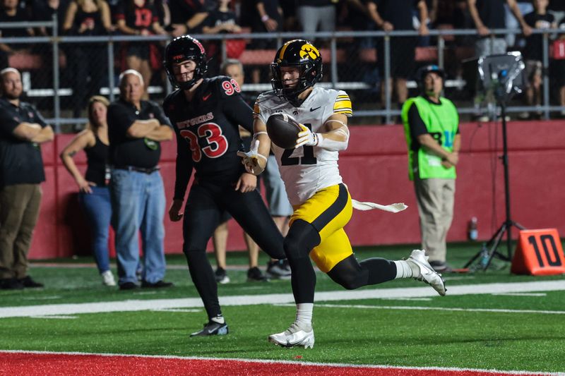 Sep 19, 2025; Piscataway, New Jersey, USA; Iowa Hawkeyes wide receiver Kaden Wetjen (21) returns the opening kick off for a touchdown during the first quarter against the Rutgers Scarlet Knights at SHI Stadium. Mandatory Credit: Vincent Carchietta-Imagn Images