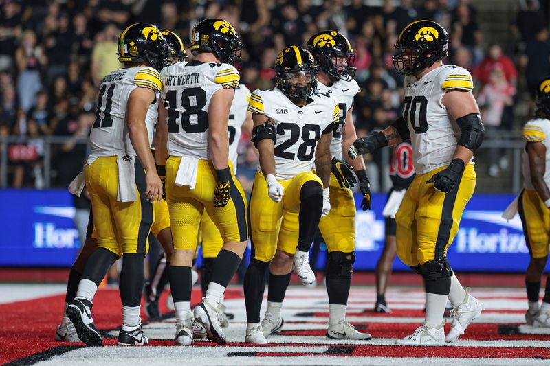 Sep 19, 2025; Piscataway, New Jersey, USA; Iowa Hawkeyes running back Kamari Moulton (28) celebrates his rushing touchdown with teammates during the first half against the Rutgers Scarlet Knights at SHI Stadium. Mandatory Credit: Vincent Carchietta-Imagn Images