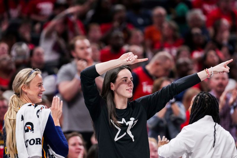 July 3, 2025; Indianapolis, Indiana, USA; Indiana Fever guards Sophie Cunningham and Caitlin Clark celebrate from the bench during a game against the Las Vegas Aces at Gainbridge Fieldhouse. Mandatory Credit: Grace Smith/INDIANAPOLIS STAR-Imagn Images
