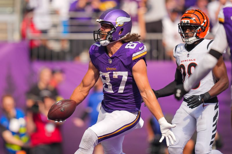 Sep 21, 2025; Minneapolis, Minnesota, USA; Minnesota Vikings tight end TJ. Hockenson (87) catches a touchdown pass against the Cincinnati Bengals during the second half at U.S. Bank Stadium.