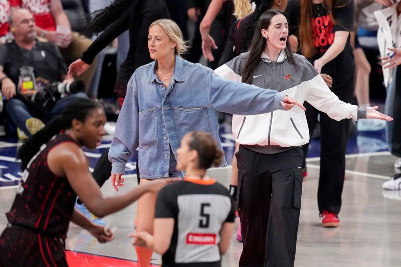 Indiana Fever guard Sophie Cunningham (8) and Indiana Fever guard Caitlin Clark (22) react from the bench to an officialâ€™s call Friday, Sept. 26, 2025, during Game 3 of the WNBA semifinals against the Las Vegas Aces at Gainbridge Fieldhouse in Indianapolis.