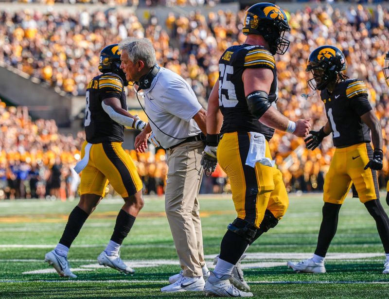 Iowa Hawkeyes head coach Kirk Ferentz high-fives his players as they come off the field against the Indiana Hoosiers Sept. 27, 2025 at Kinnick Stadium in Iowa City, Iowa.