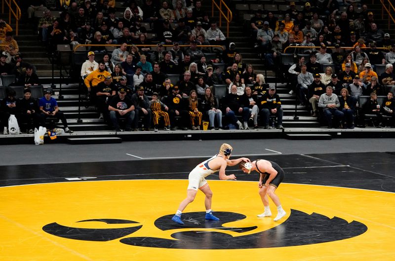 Iowaâ€™s Michael Caliendo wrestles Illinoisâ€™ Braeden Scoles in a 165-pound match Friday, Jan. 17, 2025 at Carver-Hawkeye Arena in Iowa City, Iowa.
