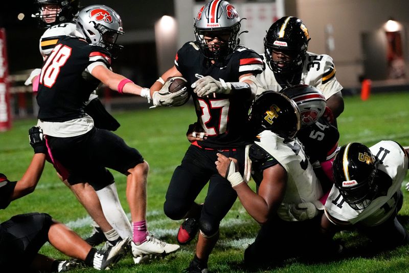 City High’s Dominic Roe (27) carries the ball during a high school football game against Southeast Polk Oct. 3, 2025 at Iowa City High in Iowa City, Iowa.