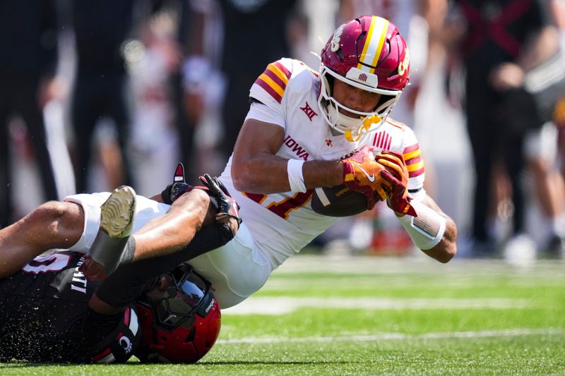 Oct 4, 2025; Cincinnati, Ohio, USA; Iowa State Cyclones wide receiver Dominic Overby (11) makes a catch against Cincinnati Bearcats cornerback Matthew McDoom (0) in the first half at Nippert Stadium. Mandatory Credit: Aaron Doster-Imagn Images