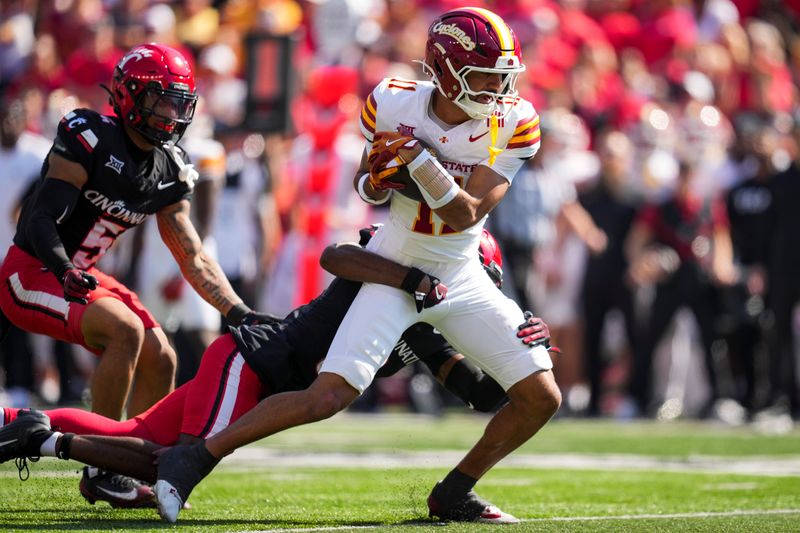 Oct 4, 2025; Cincinnati, Ohio, USA; Iowa State Cyclones wide receiver Dominic Overby (11) makes a catch against Cincinnati Bearcats cornerback Matthew McDoom (0) in the first half at Nippert Stadium. Mandatory Credit: Aaron Doster-Imagn Images