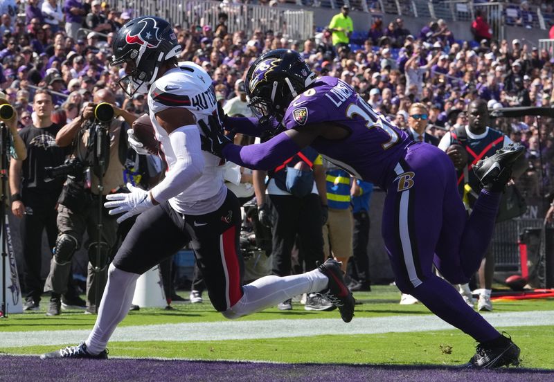 Oct 5, 2025; Baltimore, Maryland, USA; Houston Texans wide receiver Xavier Hutchinson (19) runs for a touchdown past Baltimore Ravens running back D'Ernest Johnson (30) during the first quarter at M&T Bank Stadium. Mandatory Credit: Mitch Stringer-Imagn Images