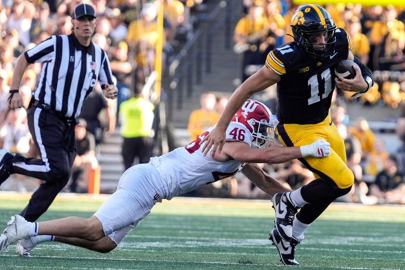 Iowa Hawkeyes quarterback Mark Gronowski (11) is tackled by Indiana Hoosiers linebacker Isaiah Jones (46) Sept. 27, 2025 at Kinnick Stadium in Iowa City, Iowa.