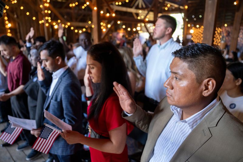 Addiel Martinez, originally of Mexico, takes the US Citizenship Oath of Allegiance during a naturalization ceremony at Living History Farms in Urbandale, Oct. 10, 2025.
