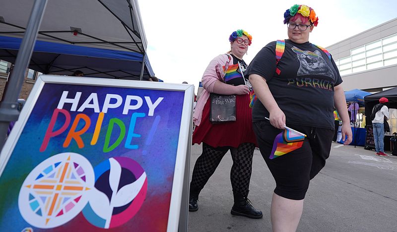 Chloe Enos and Tayler Vandehaar enjoy looking around at the annual Pridefest in downtown Ames on Oct. 11, 2025.