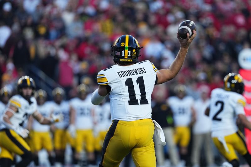 Oct 11, 2025; Madison, Wisconsin, USA; Iowa Hawkeyes quarterback Mark Gronowski (11) attempts a pass in the first quarter against the Wisconsin Badgers at Camp Randall Stadium. Mandatory Credit: Ross Harried-Imagn Images