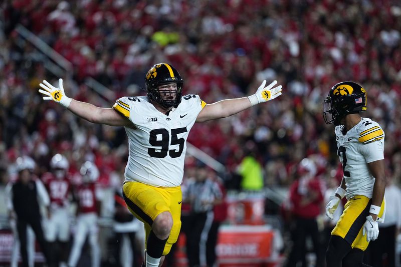 Oct 11, 2025; Madison, Wisconsin, USA; Iowa Hawkeyes defensive lineman Aaron Graves (95) celebrates a defensive stop against the Wisconsin Badgers at Camp Randall Stadium. Mandatory Credit: Ross Harried-Imagn Images