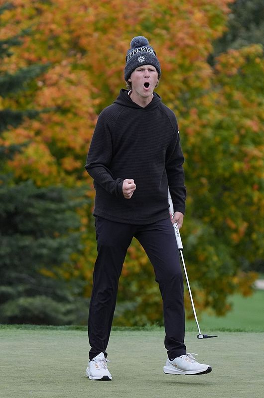 Johnston’s Andrew Johannsen celebrates after winning the Class 4A individual boys state golf championship at the Hyperion Field Club on Oct. 14, 2025, in Johnston, Iowa.
